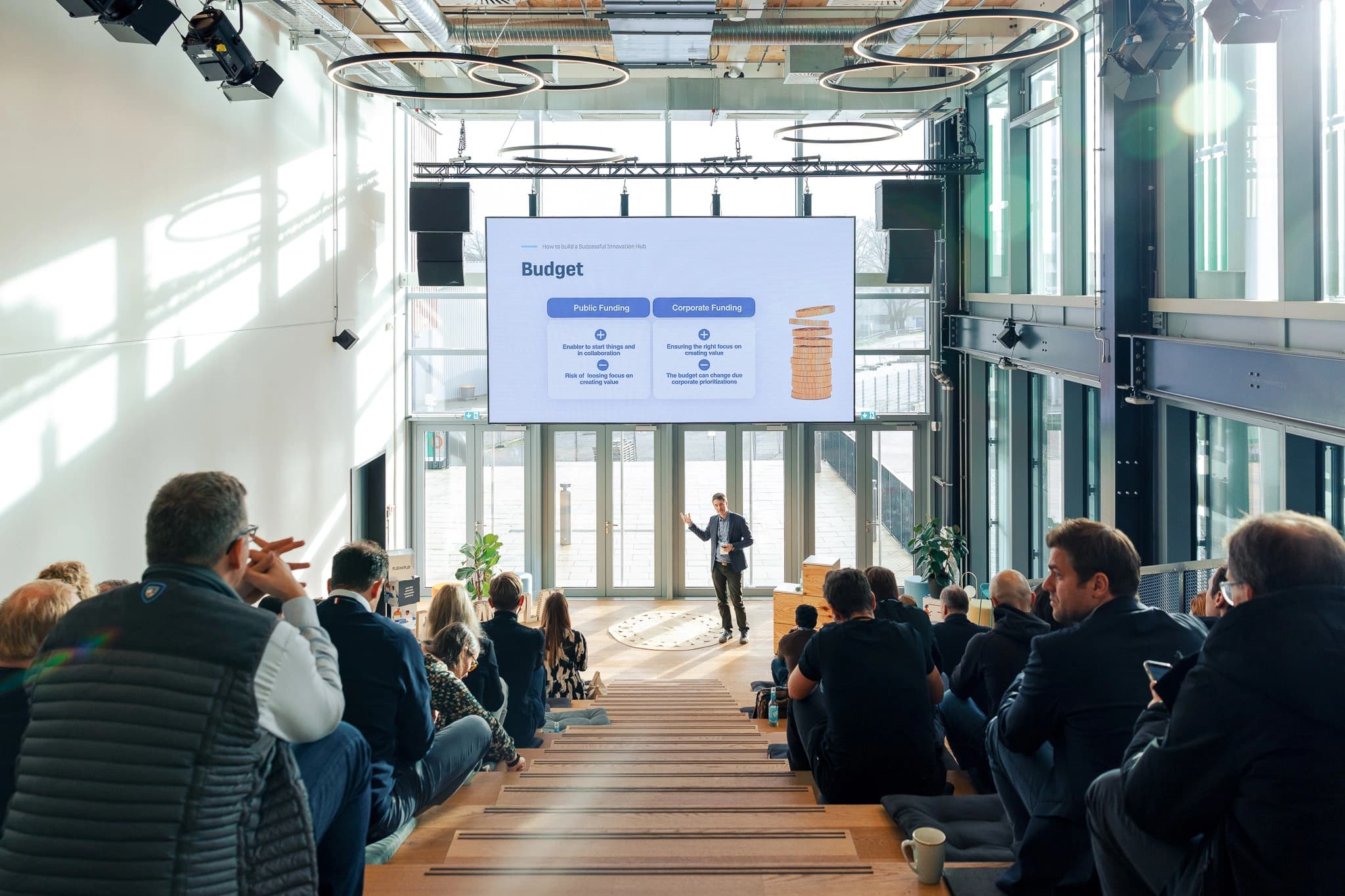 Event photographer Hamburg — conference speaker presenting to a seated business audience