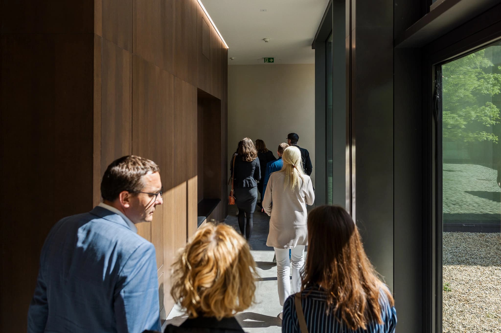 Corporate event guests walking through a Hamburg venue, photographed by Liza Holiarchuk